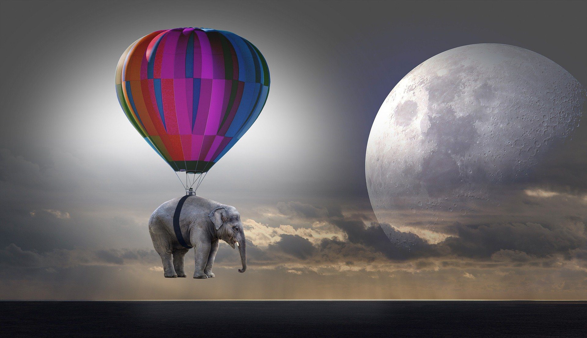 un elefante vola verso la luna sorretto da una mongolfiera